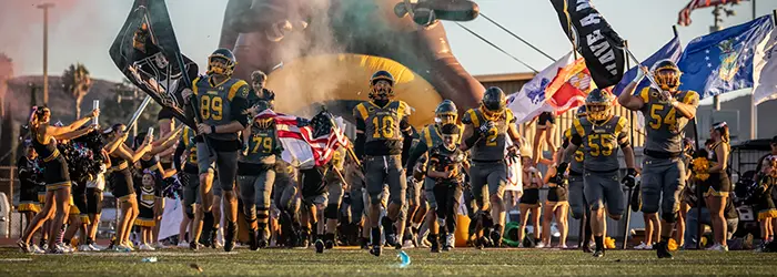 El Capitan Vaqueros Football hitting the field