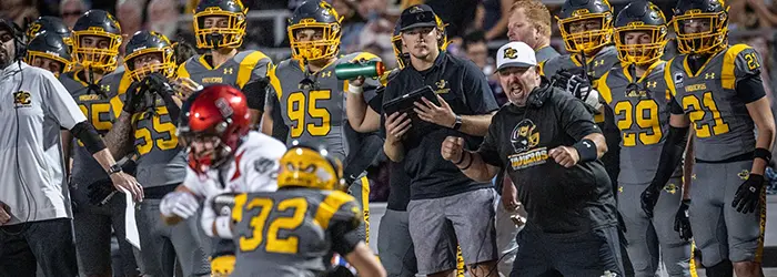 El Capitan Vaqueros Football hitting the field